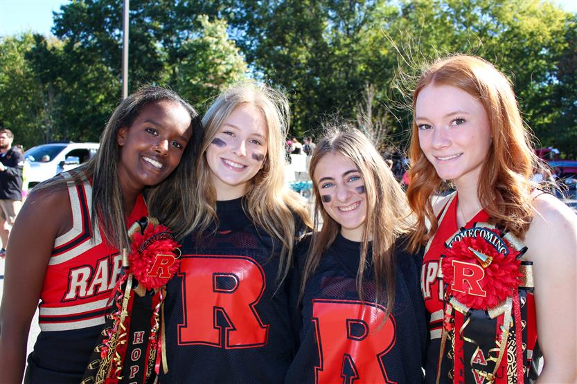 Four students smile